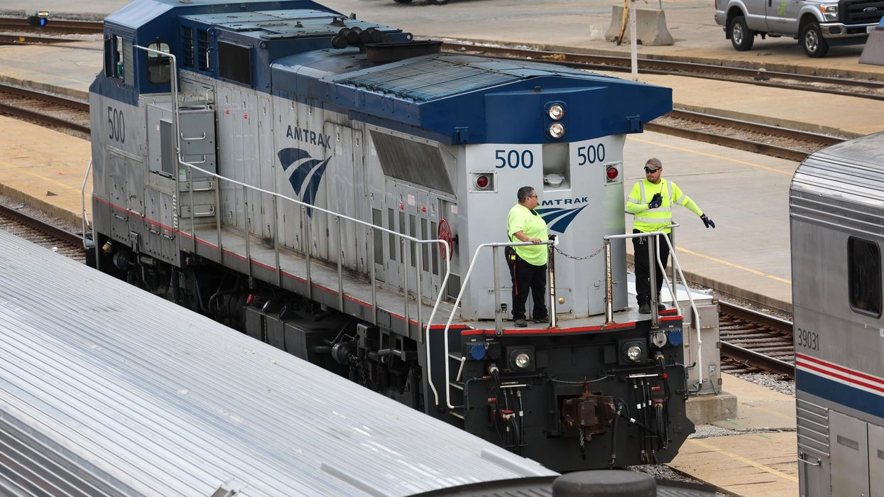 Amtrak workers service trains