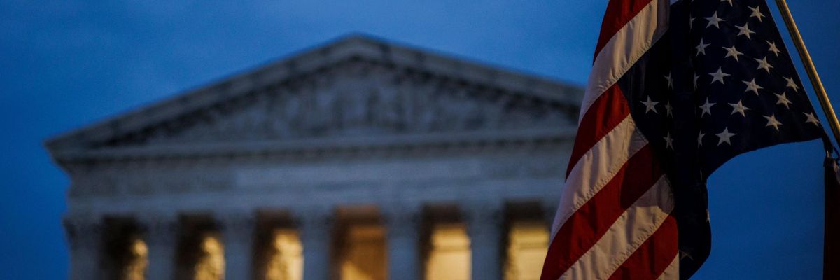An abortion rights protester flies an upside-down U.S. flag