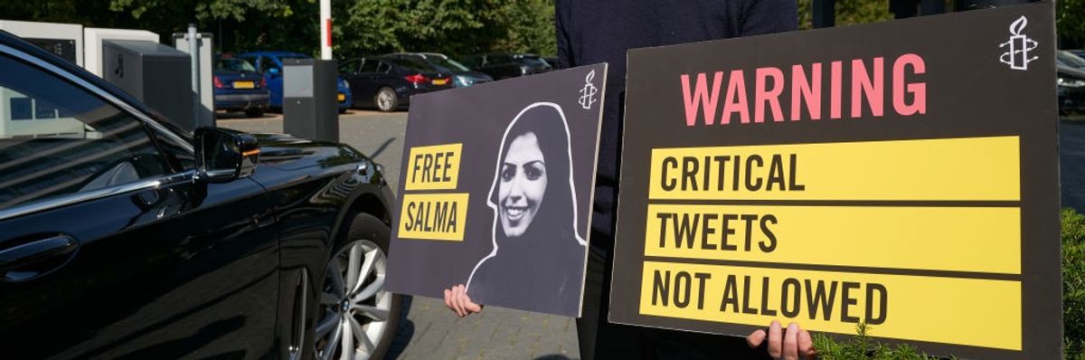 An activist holds a sign calling for Saudi authorities to free Salma al-Shehab