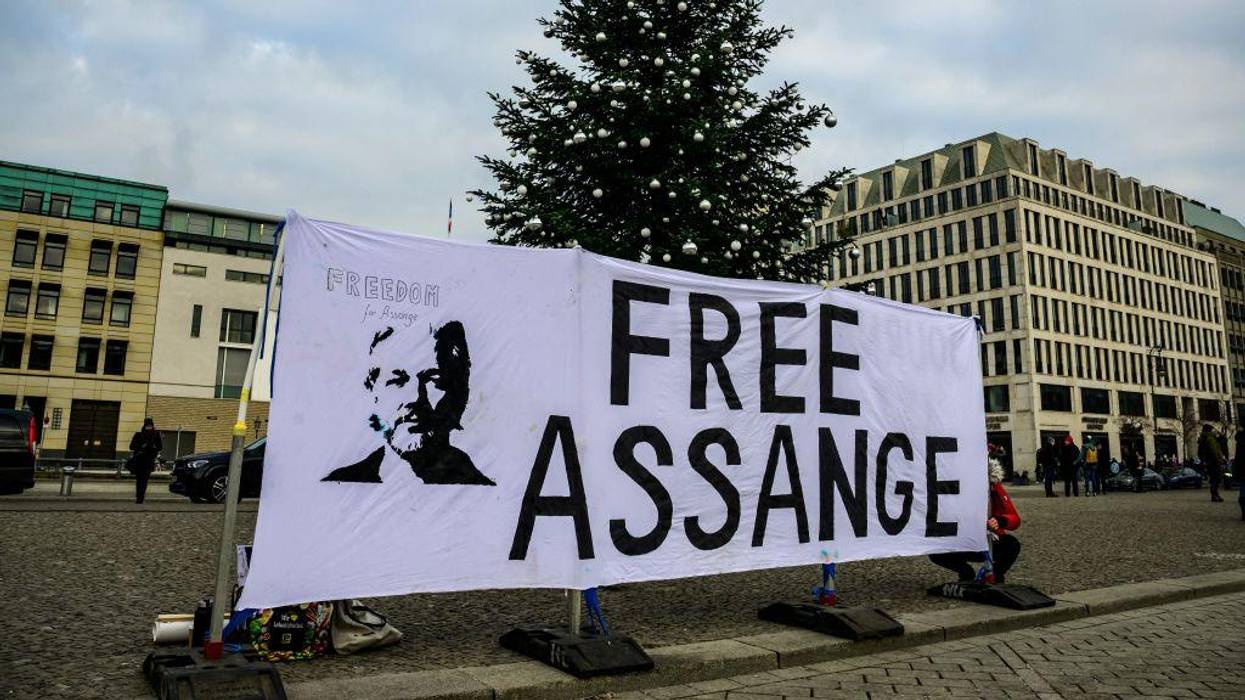 An activist puts up a banner reading "Free Assange" in front of the US embassy in Germany