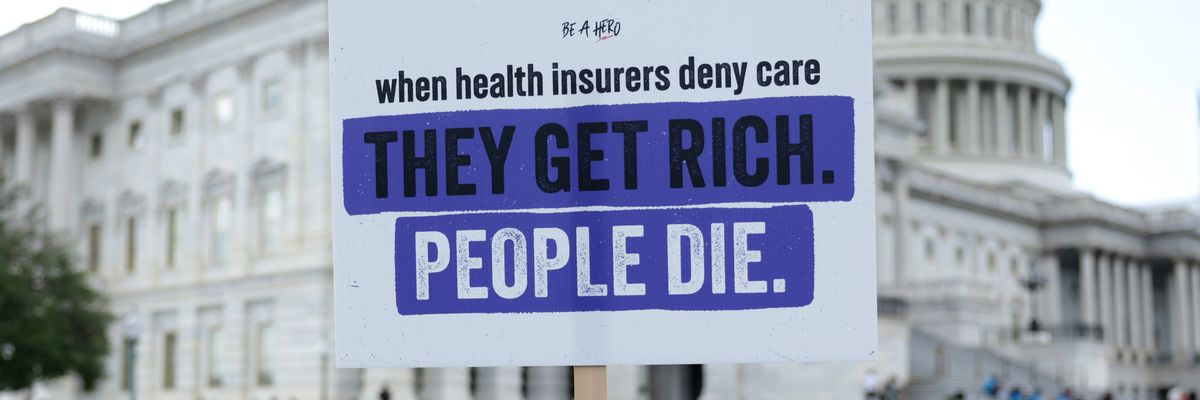 An advocate holds a sign during a news conference on Medicare Advantage plans