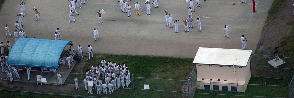 an aerial view of detainees in the yard at Alligator Alcatraz