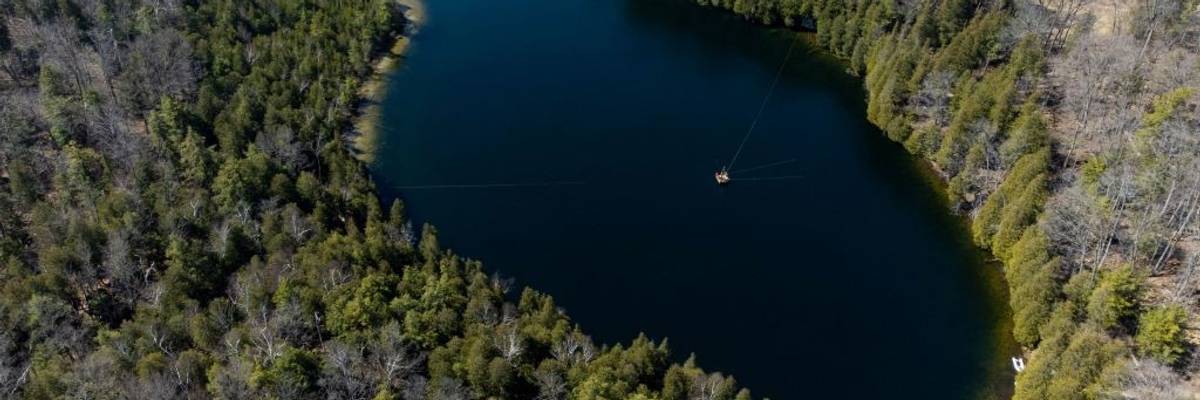 An aerial view of Lake Crawford surrounded by trees.