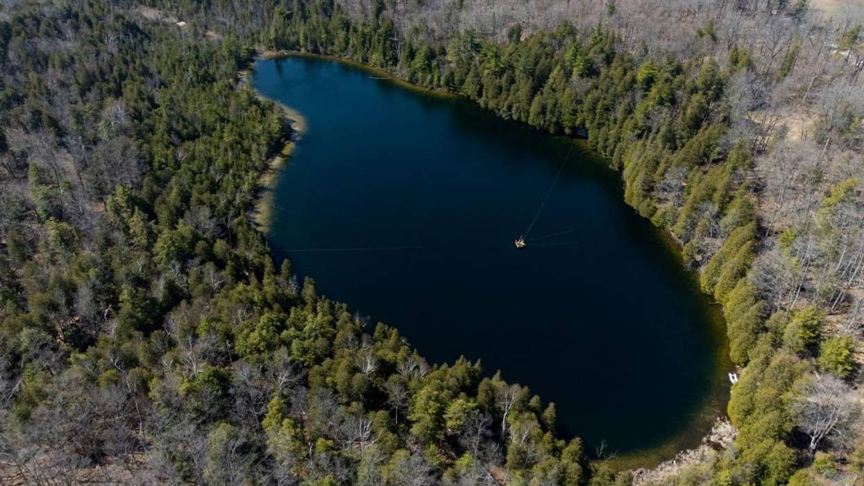 An aerial view of Lake Crawford surrounded by trees.