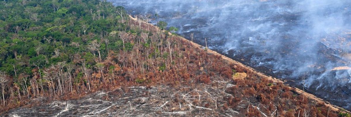 An aerial view of severe Amazon deforestation and burning