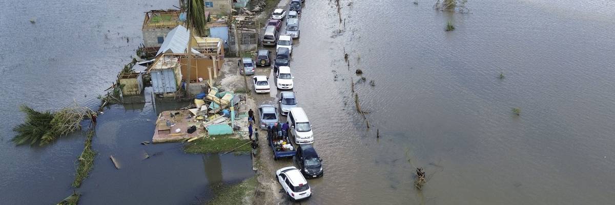 An aerial view shows cars and damaged property in Jamaica