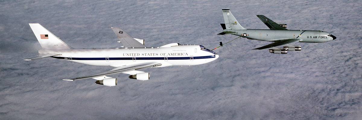 An air-to-air right side view of an E-4B advanced airborne national command post aircraft being refueled from a KC-135 Stratotanker aircraft.
