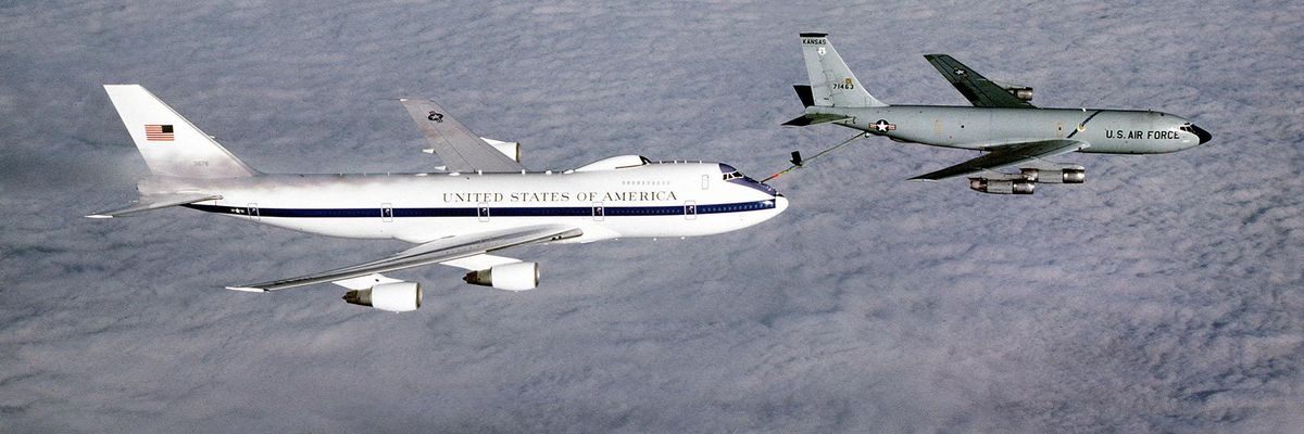 An air-to-air right side view of an E-4B advanced airborne national command post aircraft being refueled from a KC-135 Stratotanker aircraft.