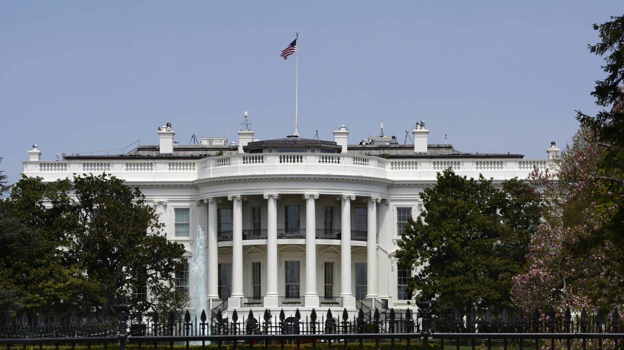 An American flag flies over the south facade of the White House in Washington, D.C.
