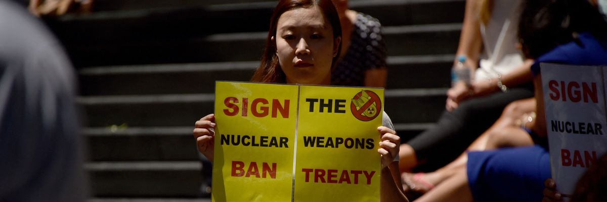 An anti-nuclear protester holds a placard at a rally in Sydney, Australia.