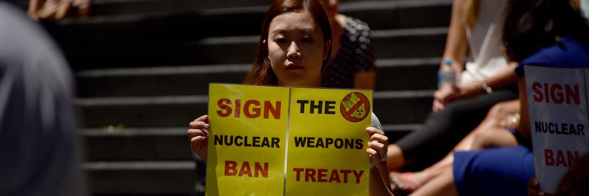 An anti-nuclear protester holds a placard at a rally in Sydney, Australia