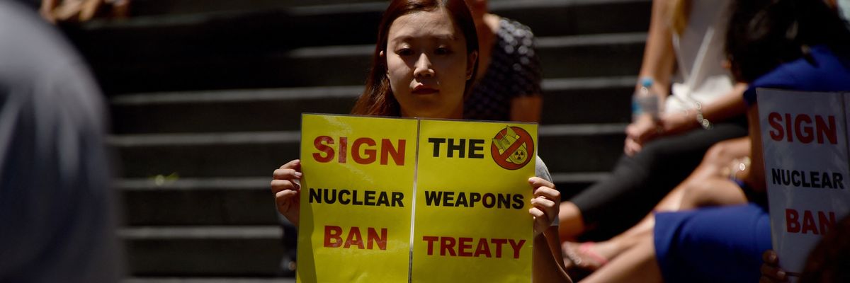 An anti-nuclear protester holds a placard at a rally in Sydney, Australia.