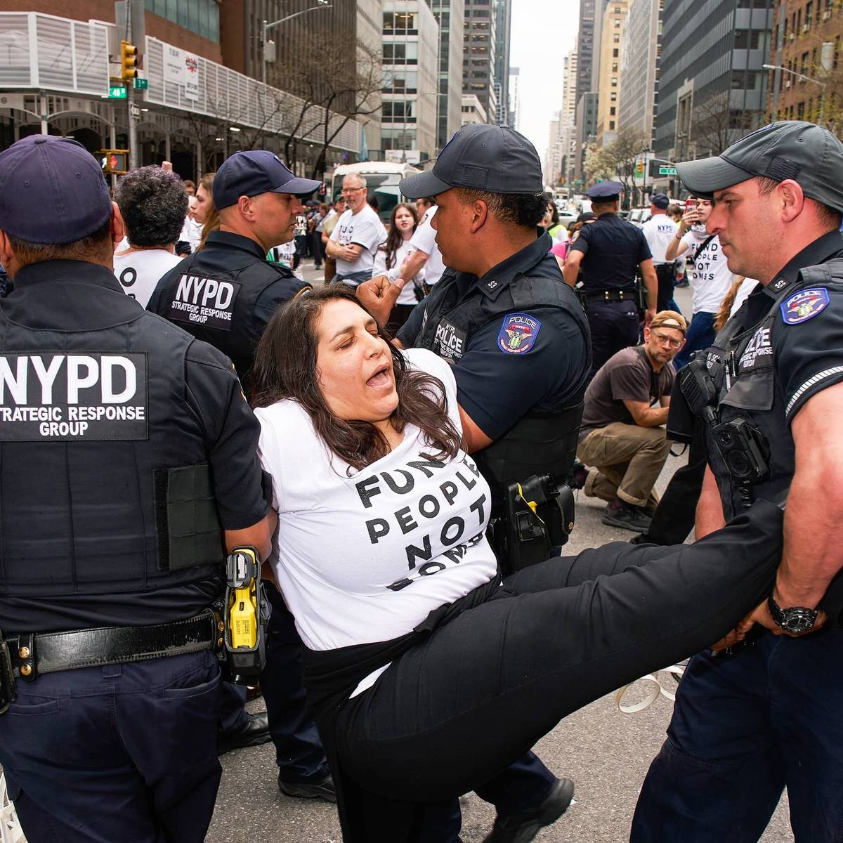 An anti-war protester is carried away from a demonstration
