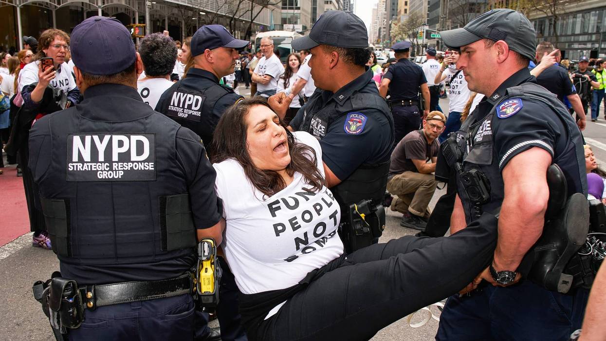 An anti-war protester is carried away from a demonstration