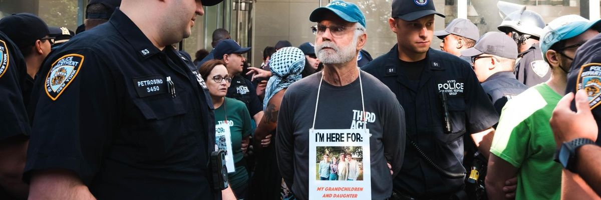 An elder climate protester named Pat is arrested by NYPD at Citibank headquarters