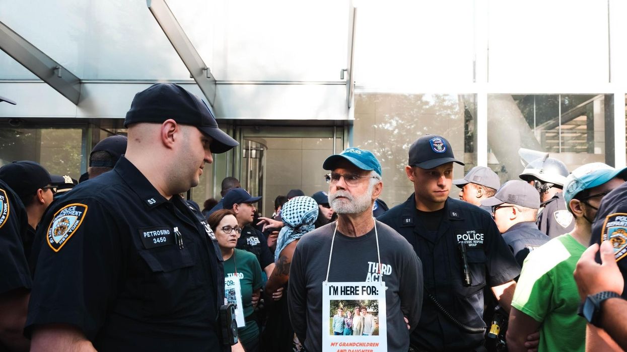 An elder climate protester named Pat is arrested by NYPD at Citibank headquarters