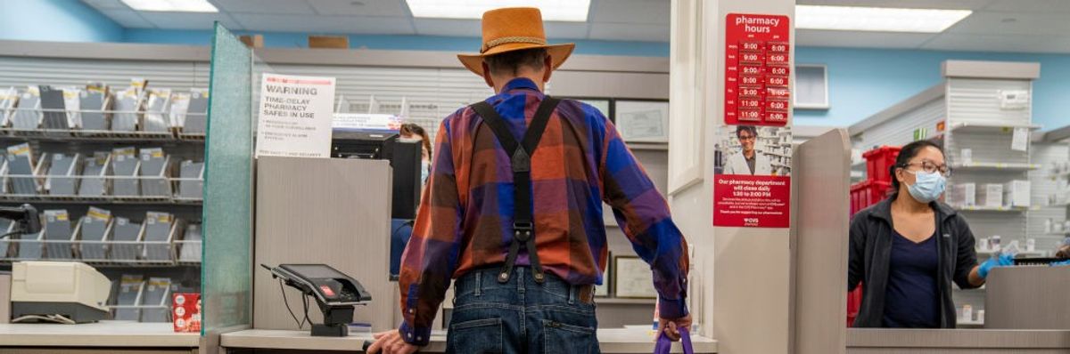 An elderly man waits for his prescription to be filled