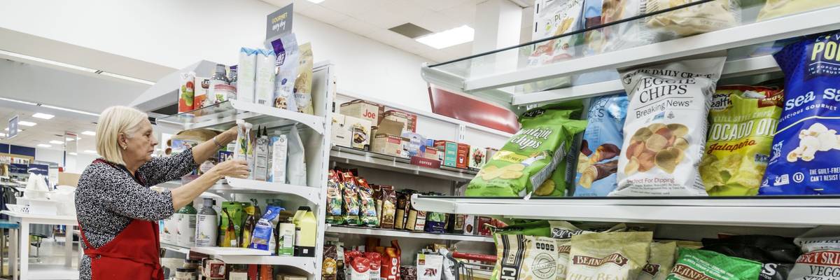 An elderly worker stocks store shelves in Miami on May 14, 2018.