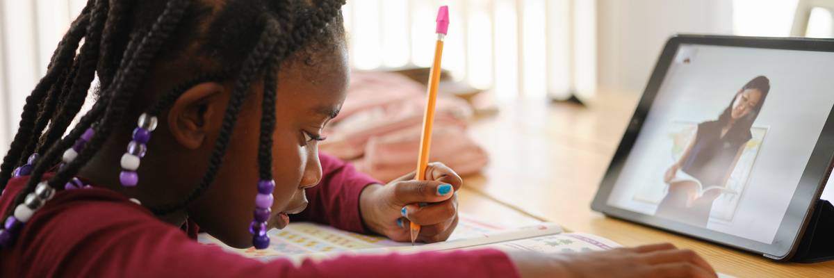 An elementary school student attends school remotely.