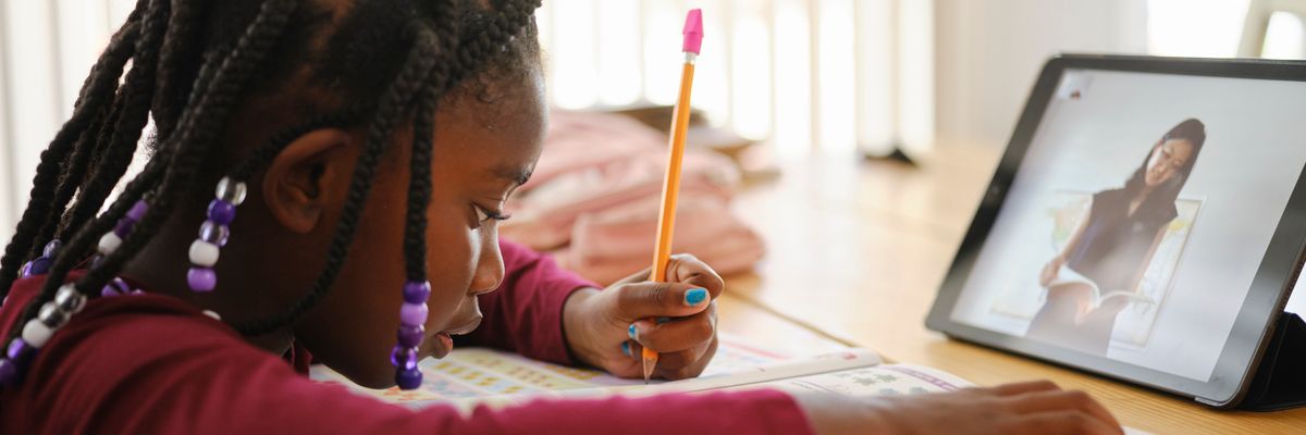 An elementary school student attends school remotely.