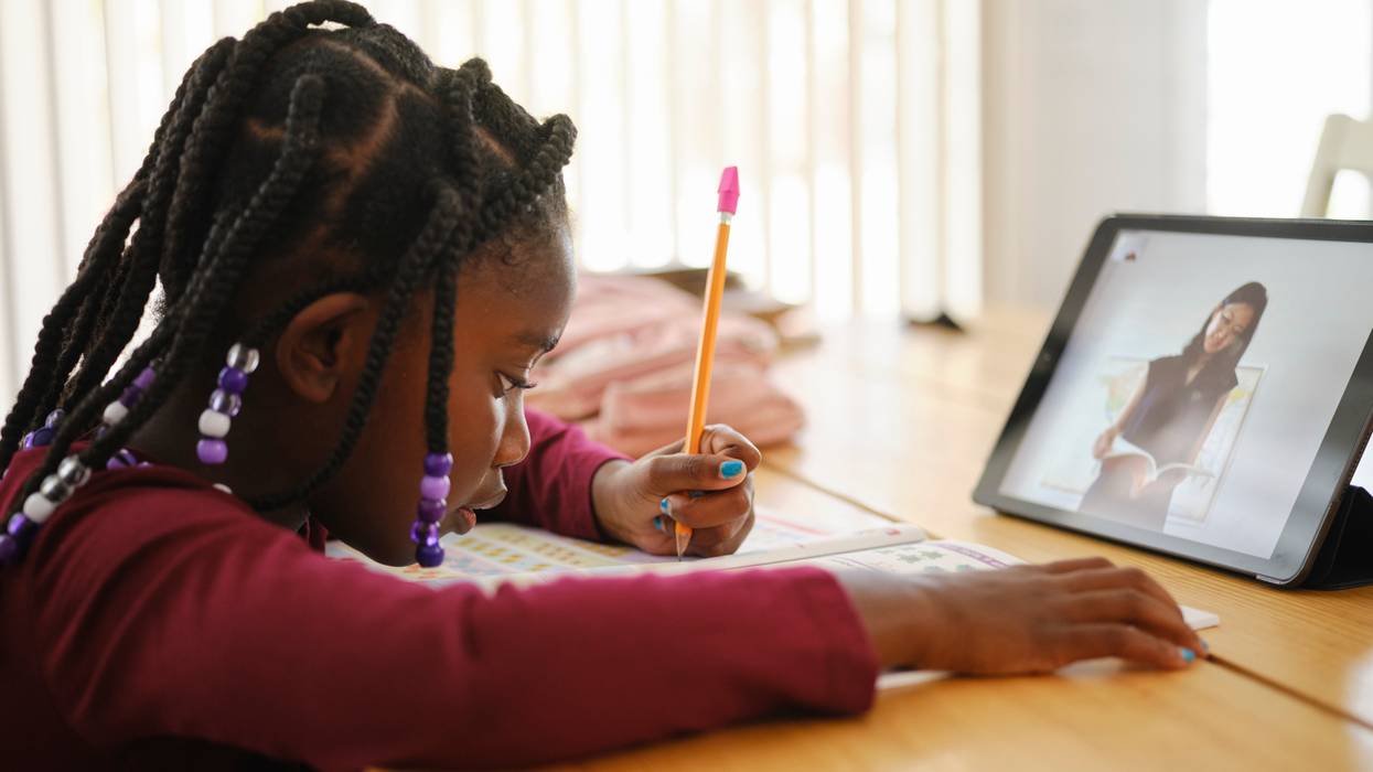 An elementary school student attends school remotely.