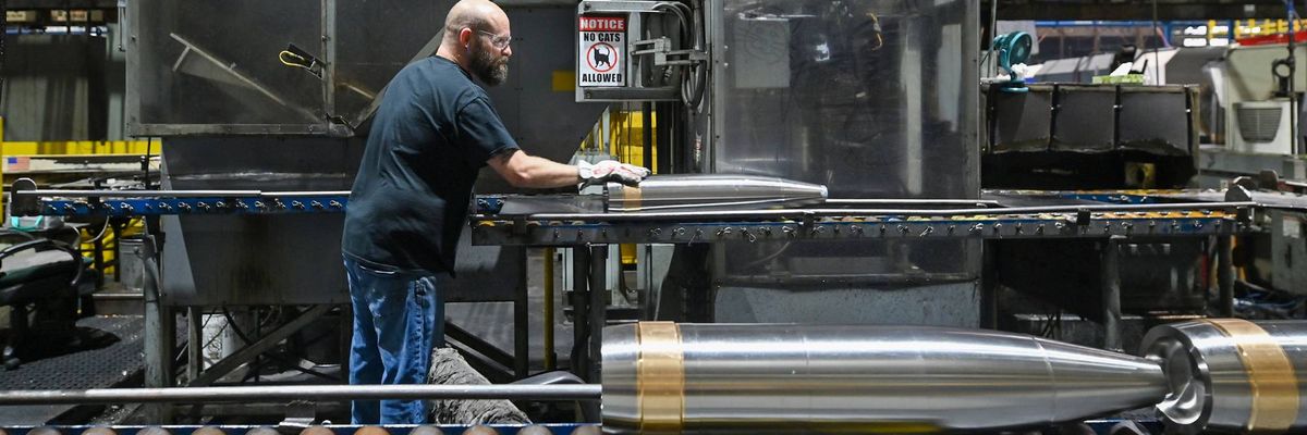 An employee at General Dynamics Scranton moves a mortar.