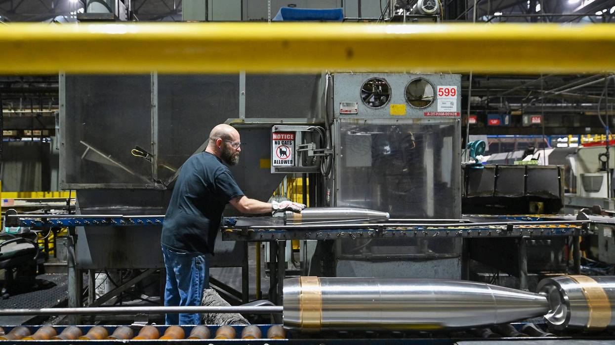 An employee at General Dynamics Scranton moves a mortar.