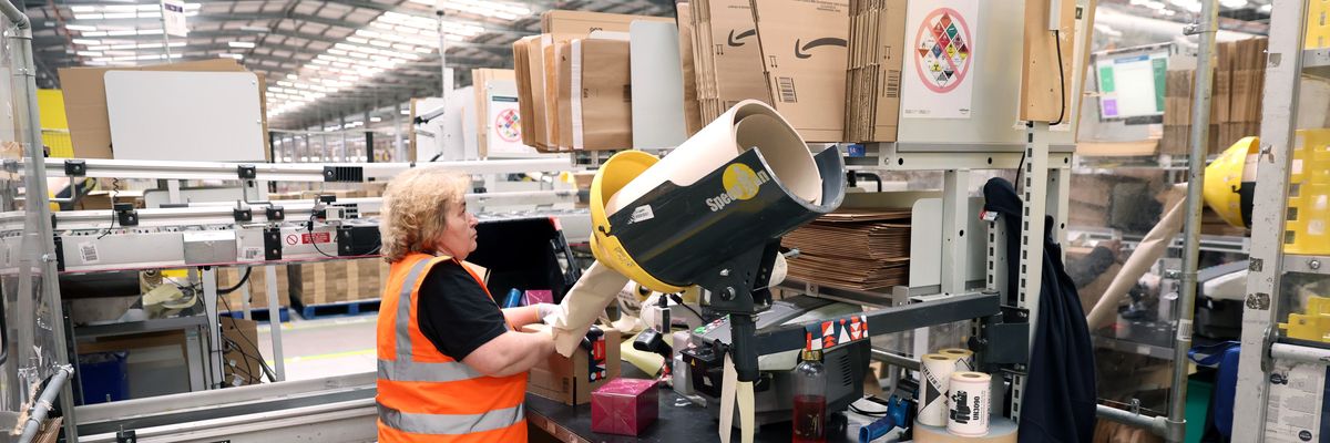 An employee packs items an Amazon fulfilment center in Rugeley, England on November 23, 2022, just before Black Friday.