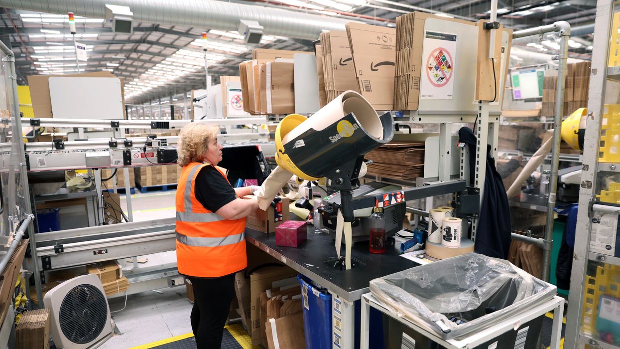 An employee packs items an Amazon fulfilment center in Rugeley, England on November 23, 2022, just before Black Friday.