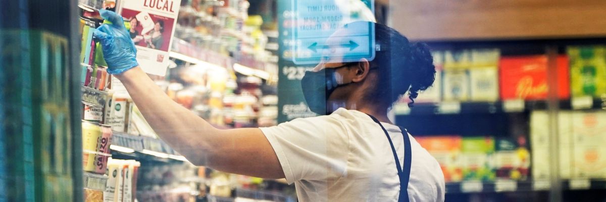 An employee works in a D.C. grocery store.