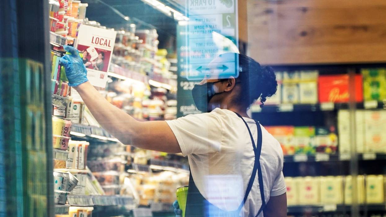 An employee works in a D.C. grocery store.