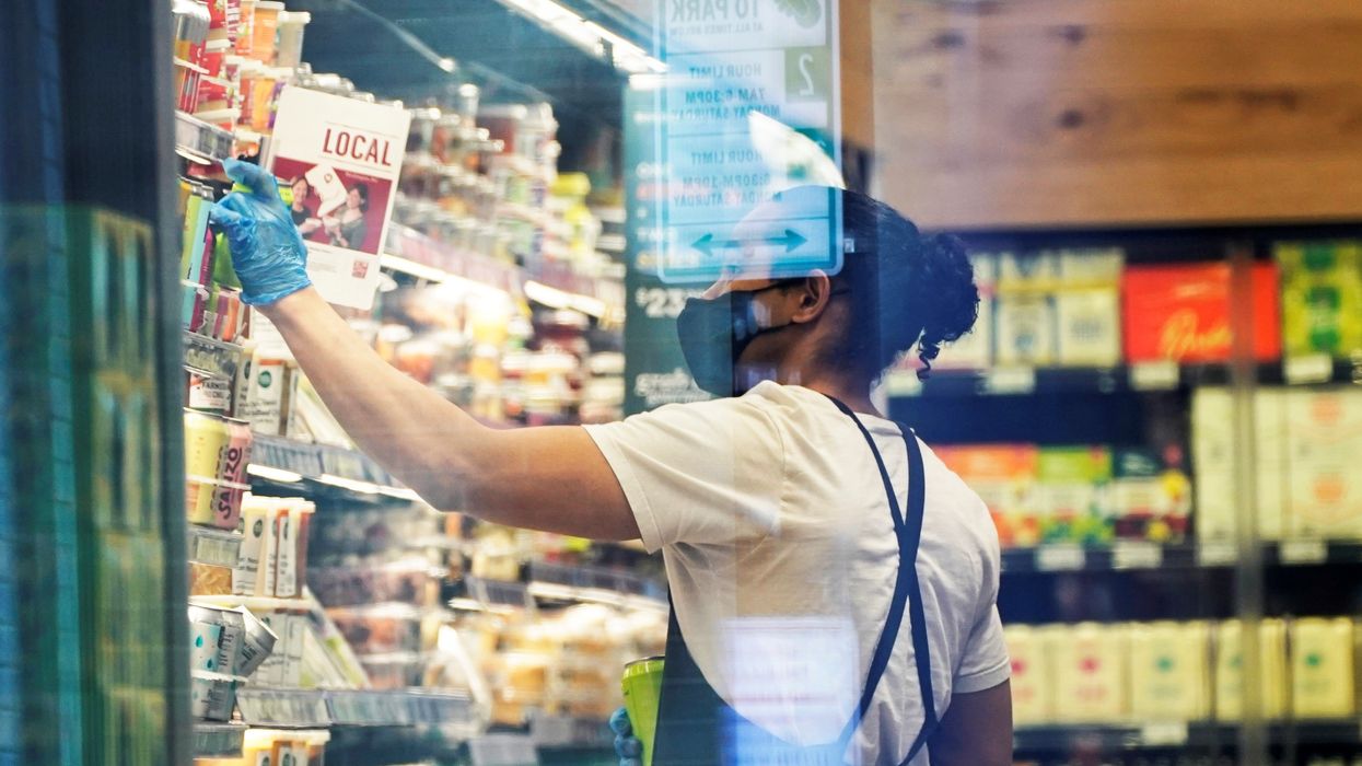 An employee works in a D.C. grocery store.