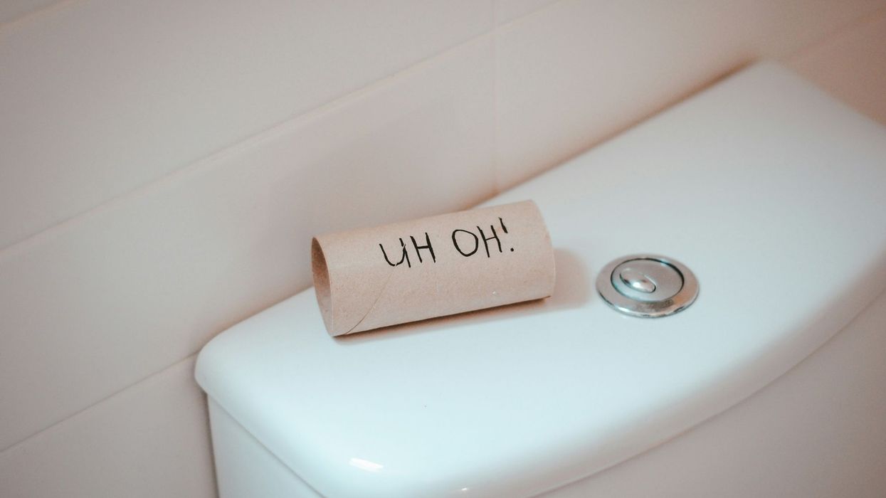 An empty roll of toilet paper on top of a toilet says, "Uh oh!"