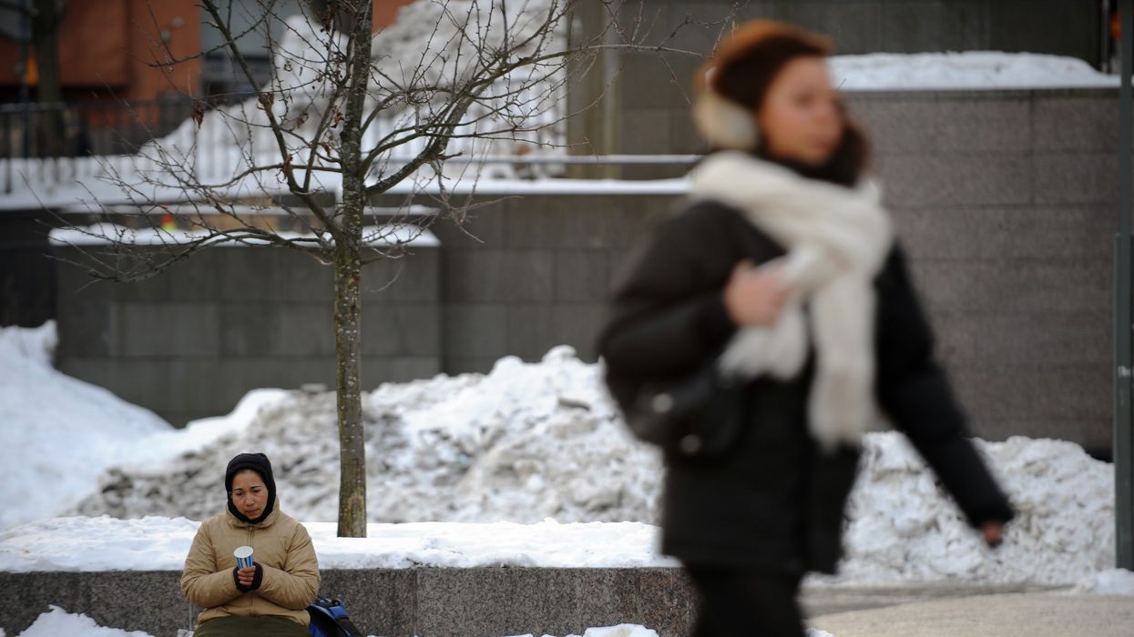 An homeless lady begs for money in Finland
