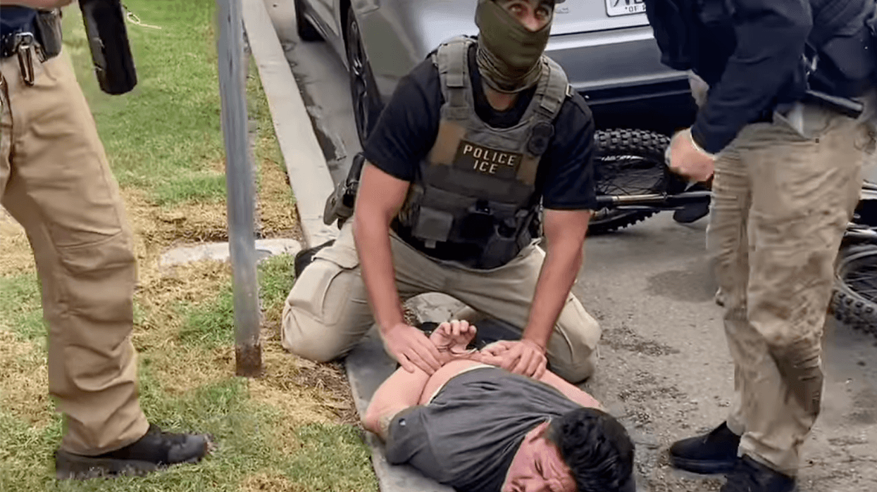 An ICE agent pins Ricardo Gonzalez to the ground