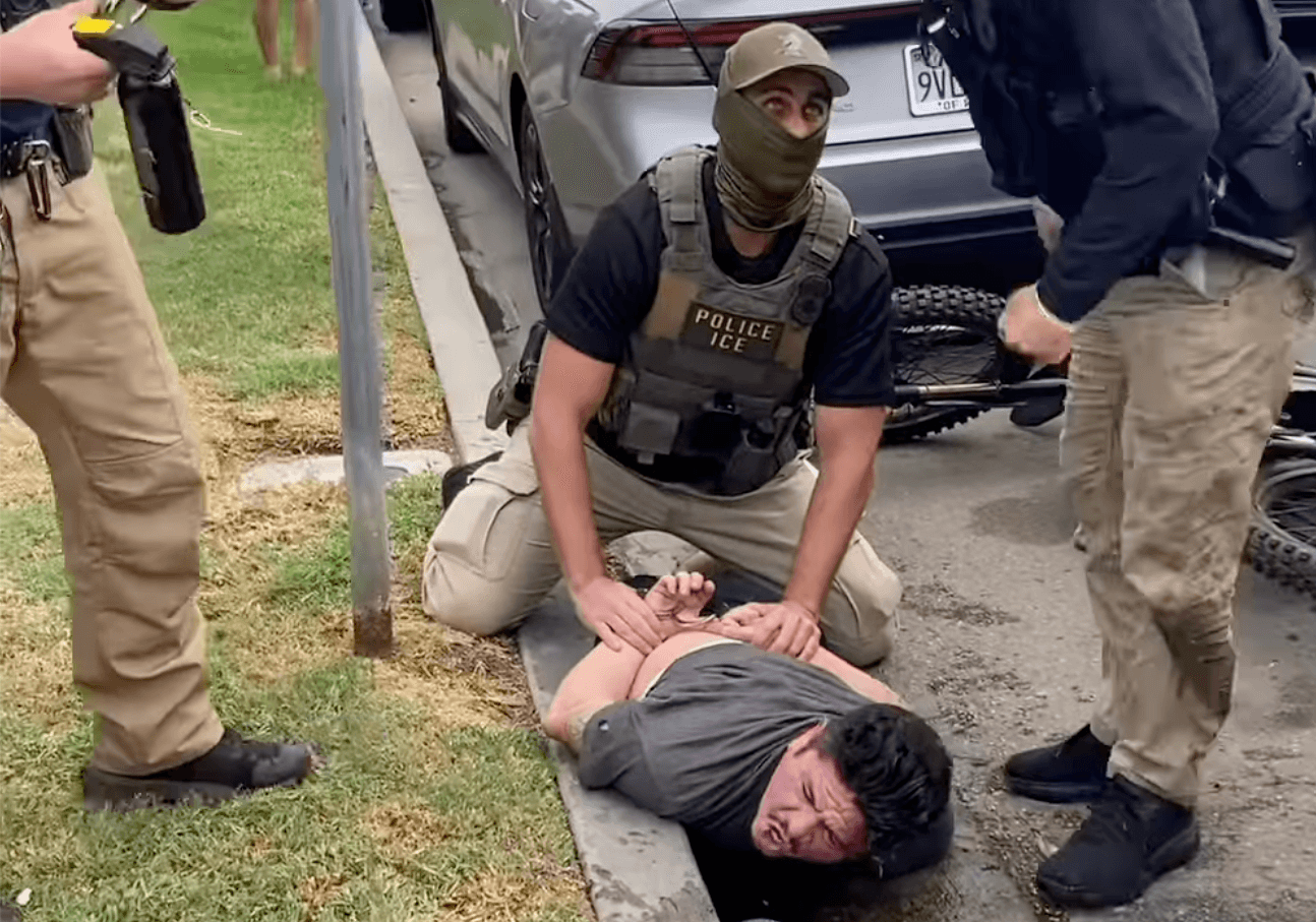 An ICE agent pins Ricardo Gonzalez to the ground