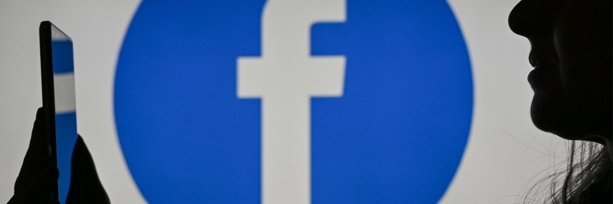 An image of a woman looking at a phone screen