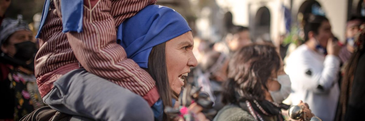 An Indigenous Mapuche woman gestures during the demonstration. Protesters gathered near the former national congress during the first day of the constitutional convention.