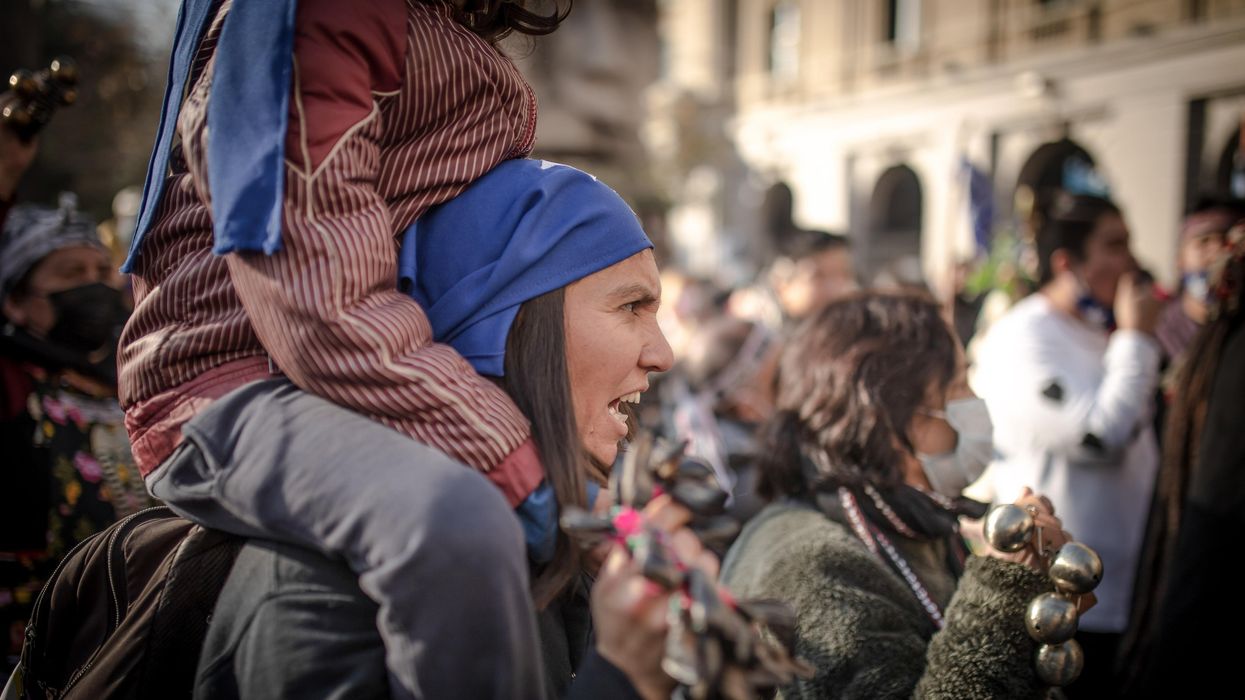 An Indigenous Mapuche woman gestures during the demonstration. Protesters gathered near the former national congress during the first day of the constitutional convention.