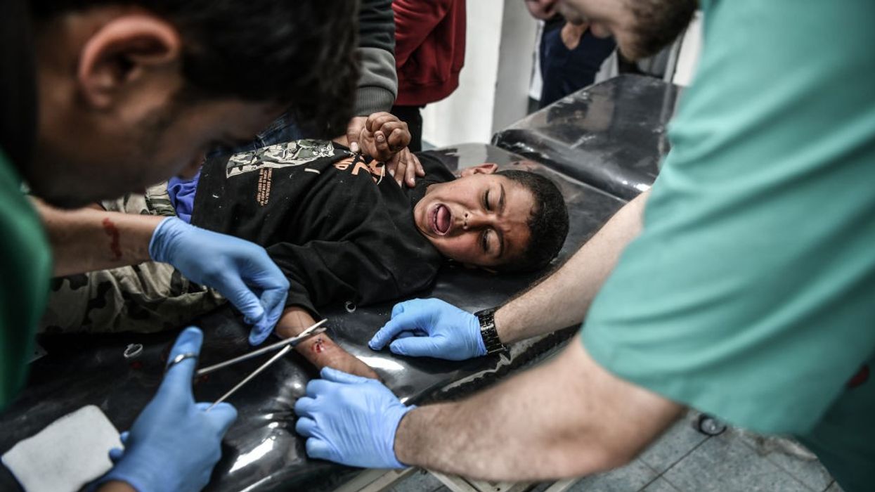 An injured Palestinian child receives medical treatment in Rafah