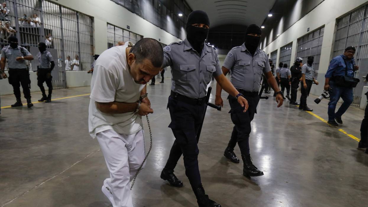 An inmate is escorted by a guard