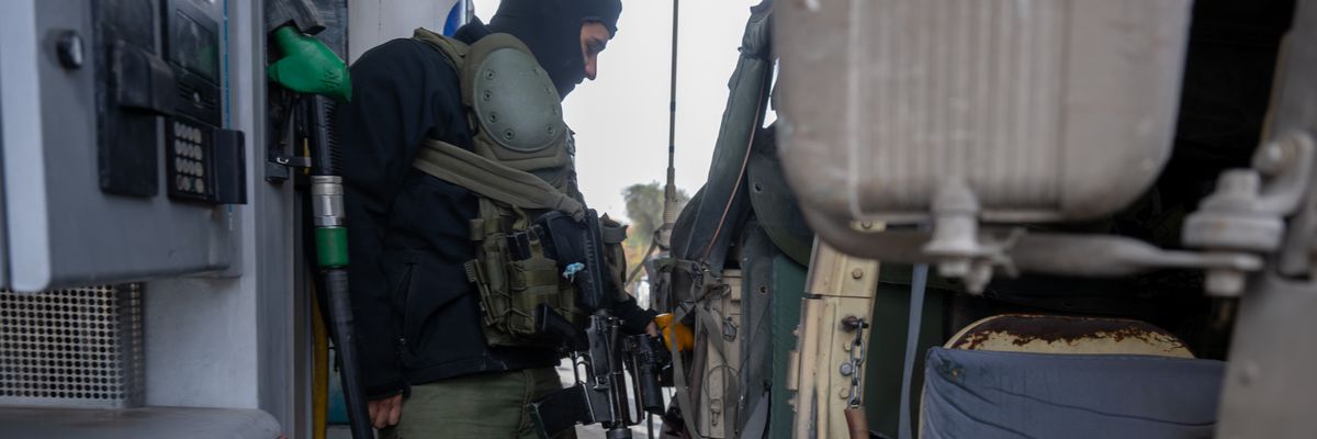 An Israel Defense Forces soldier fills a hummer with gas