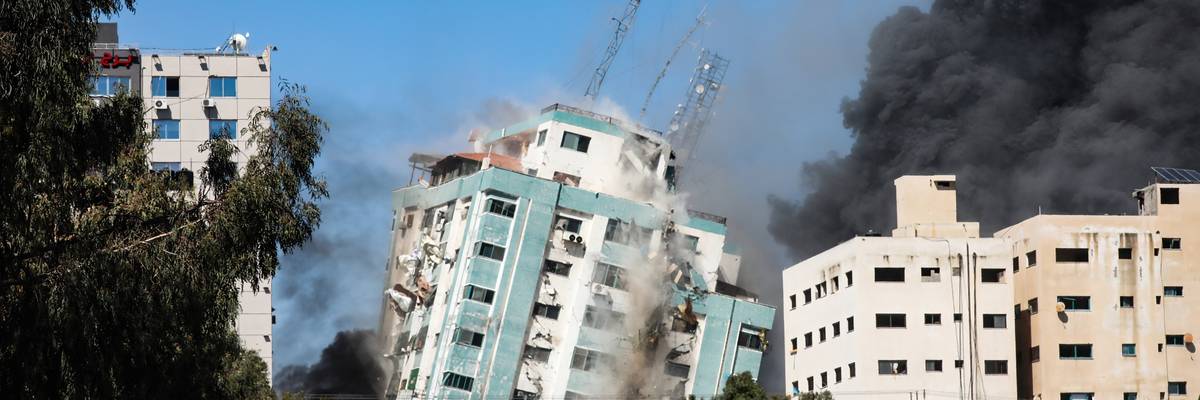 An Israeli airstrike destroys a high-rise building in Gaza