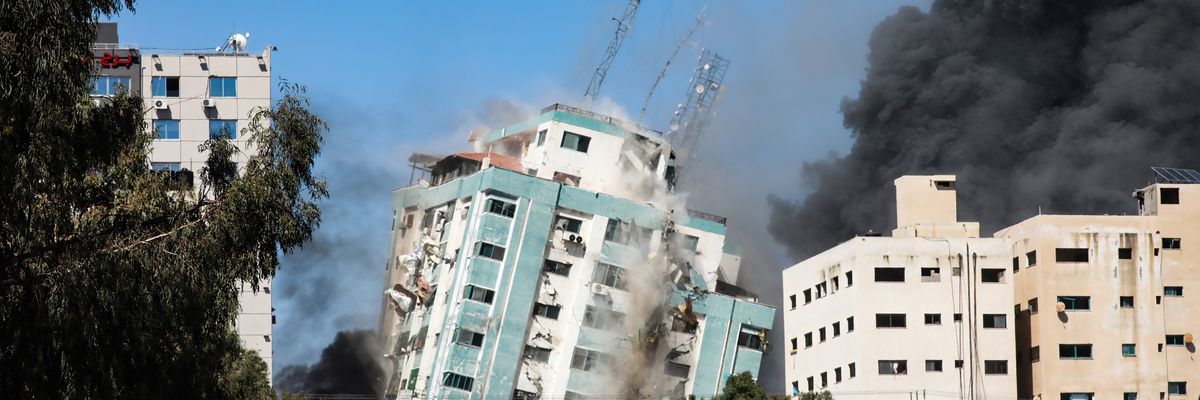 An Israeli airstrike destroys a high-rise building in Gaza
