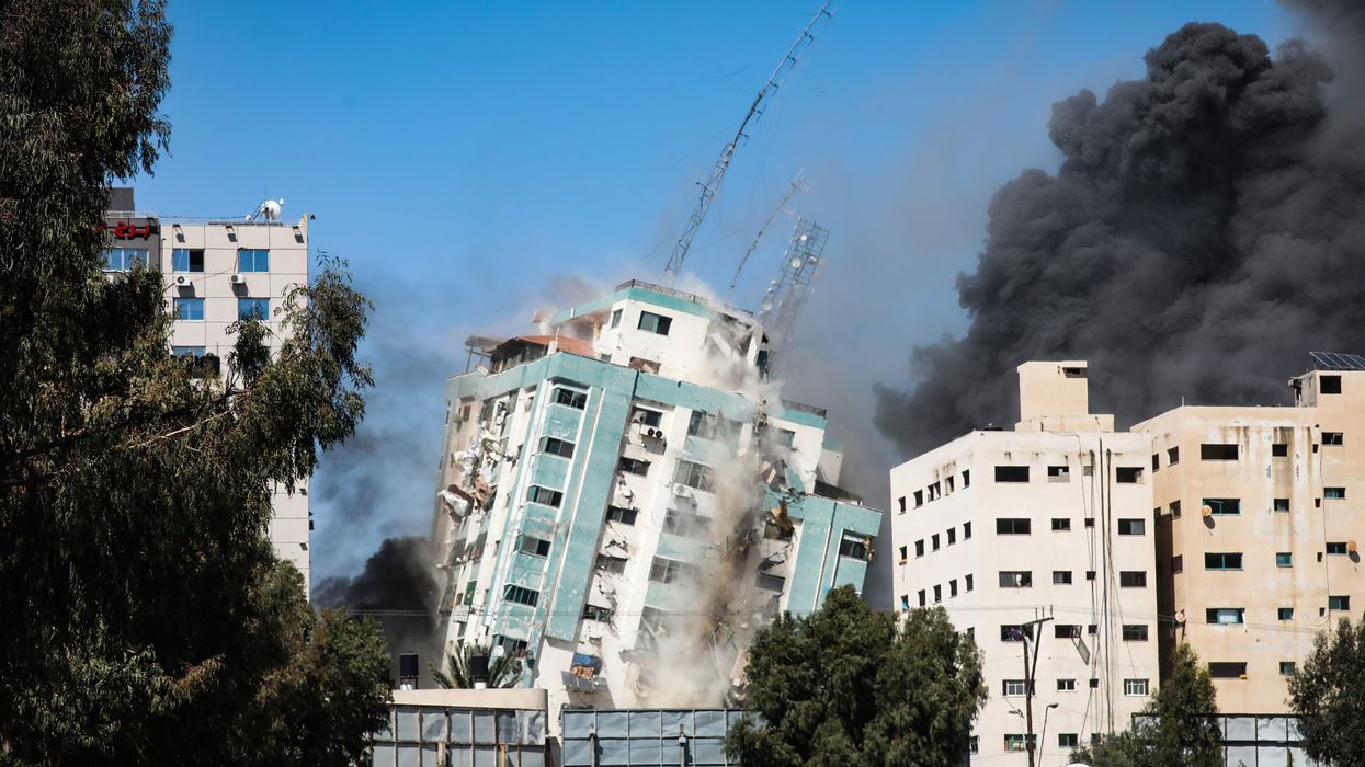 An Israeli airstrike destroys a high-rise building in Gaza