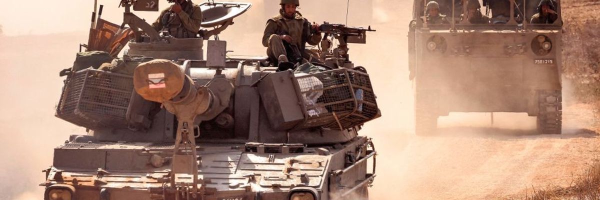 An Israeli army artillery howitzer and IDF soldiers near Gaza