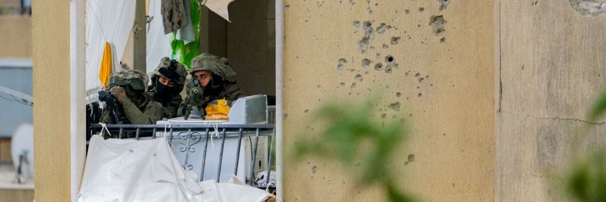 An Israeli sniper team aims at Lebanese civilians returning to their homes