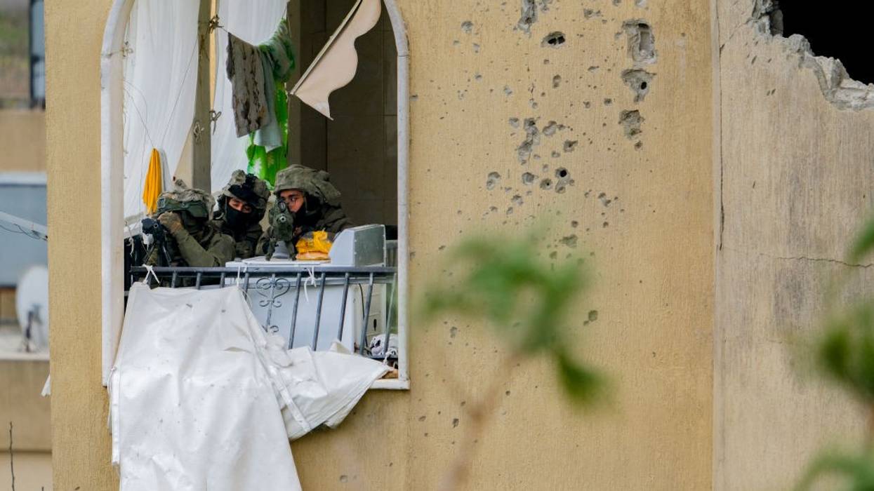 An Israeli sniper team aims at Lebanese civilians returning to their homes