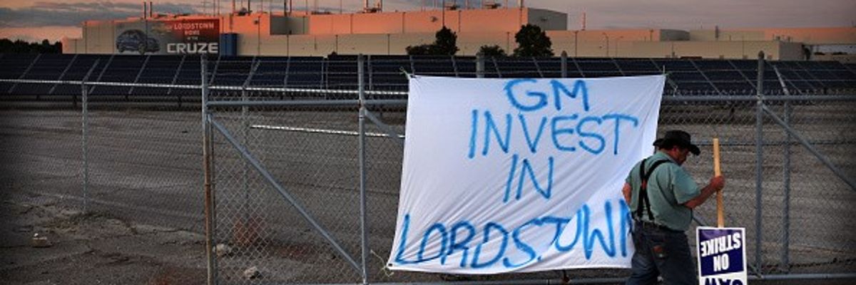 An Ohio auto worker pickets outside a shuttered factory.