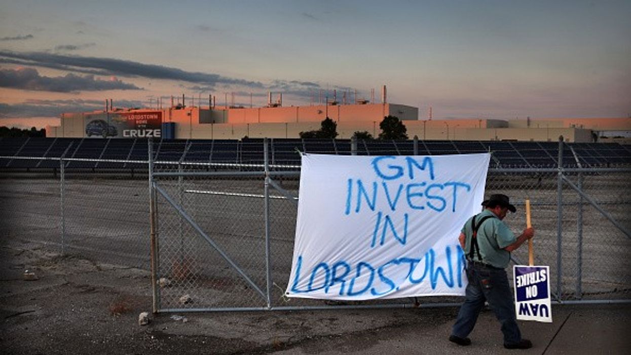 An Ohio auto worker pickets outside a shuttered factory.